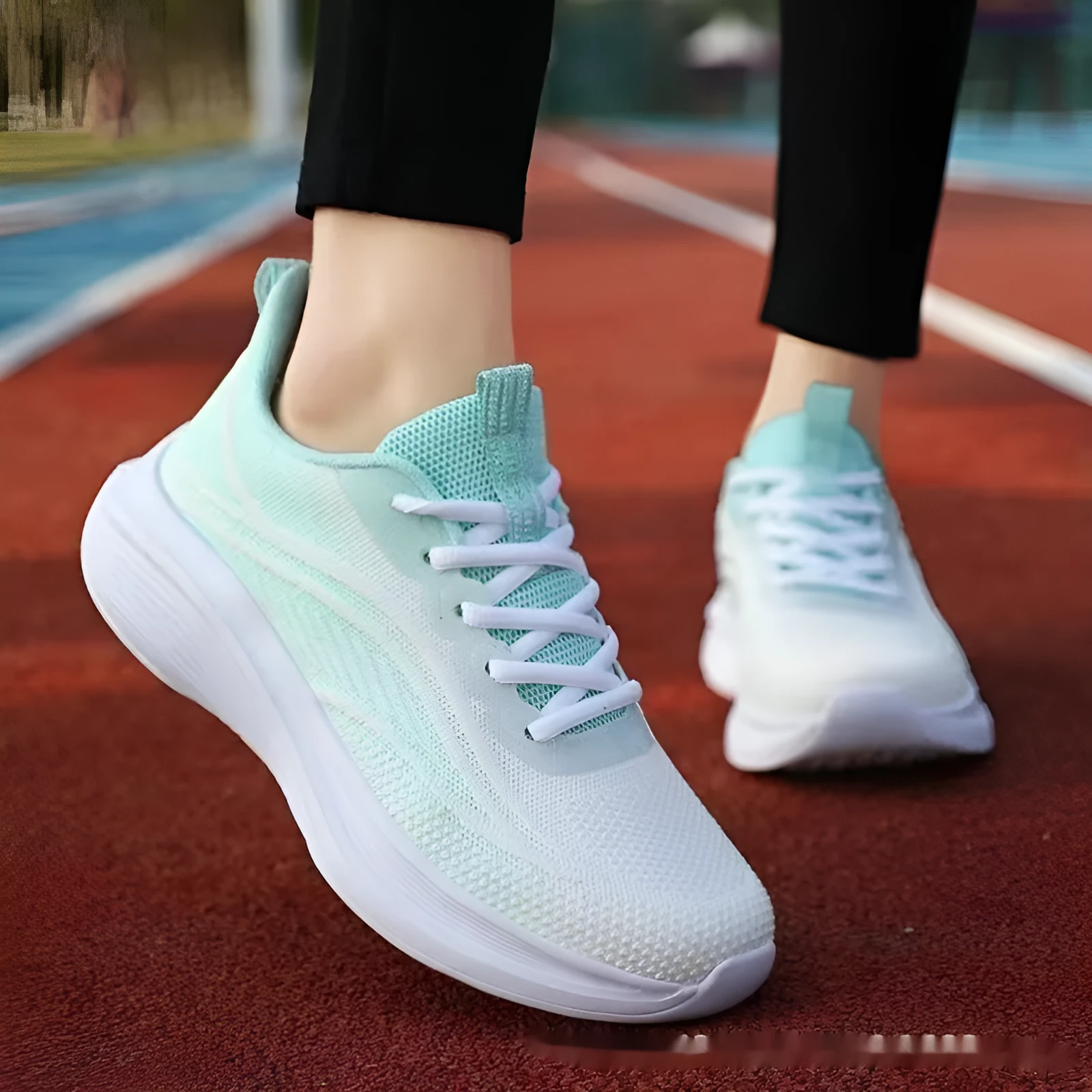 Women's low-top mesh running shoes in light pink with a round toe and front lace-up closure.