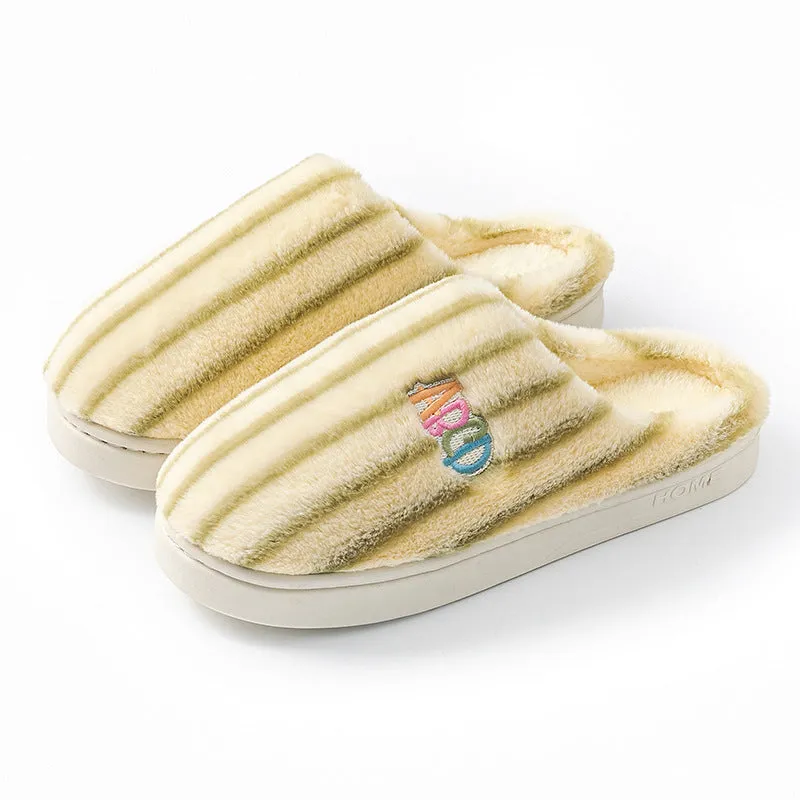 A pair of soft cotton adult slippers with a plastic sole, shown in one of five colour options.