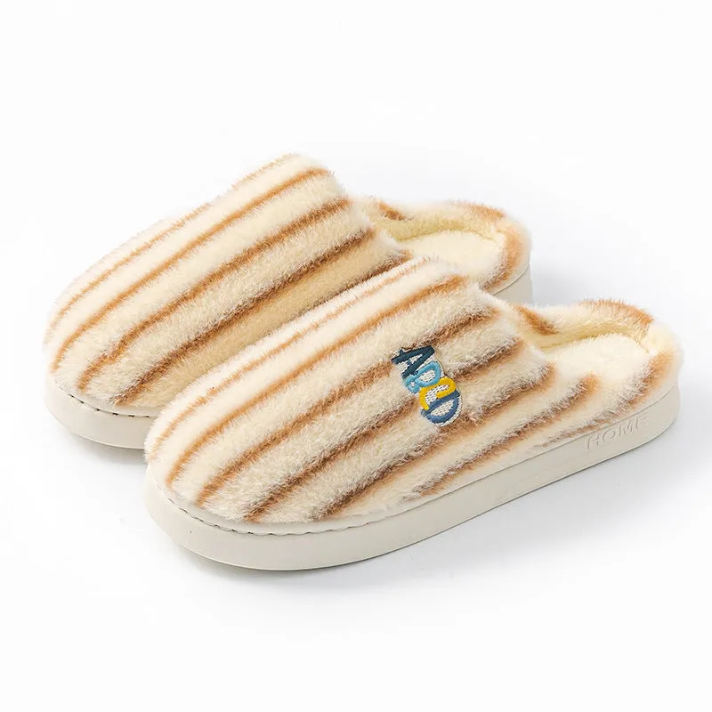 A pair of soft cotton adult slippers with a plastic sole, shown in one of five colour options.