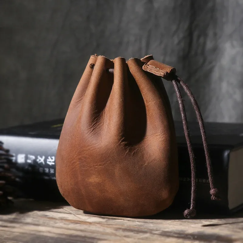 Genuine cowhide leather drawstring bundle wallet in retro style shown in black and chocolate colours.