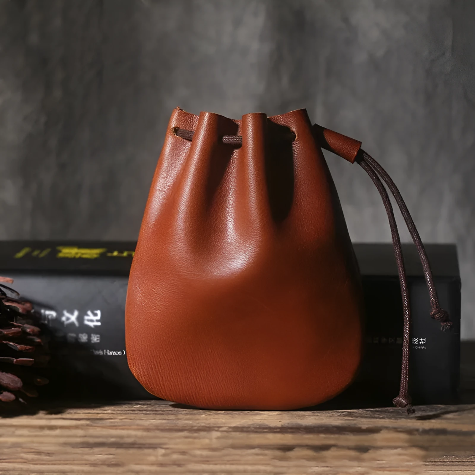 Genuine cowhide leather drawstring bundle wallet in retro style shown in black and chocolate colours.