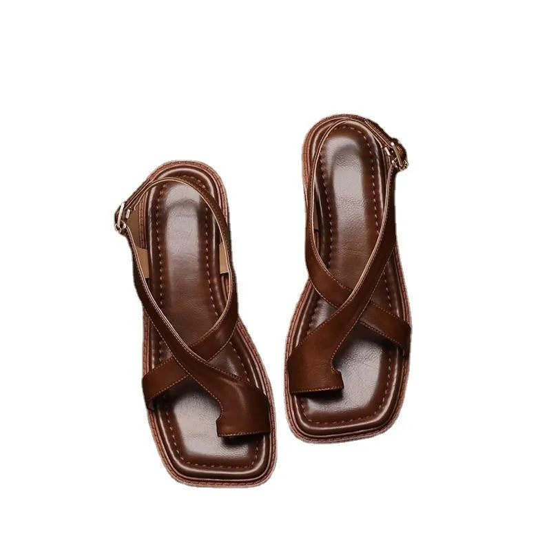French retro brown toe ring sandals with square toe and ankle-strap buckle on a neutral background