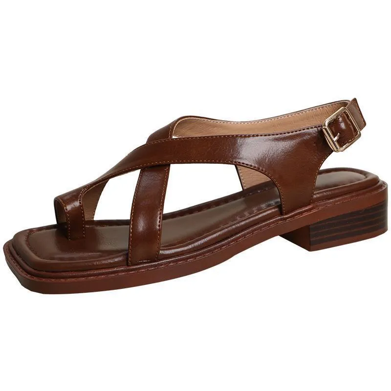 French retro brown toe ring sandals with square toe and ankle-strap buckle on a neutral background
