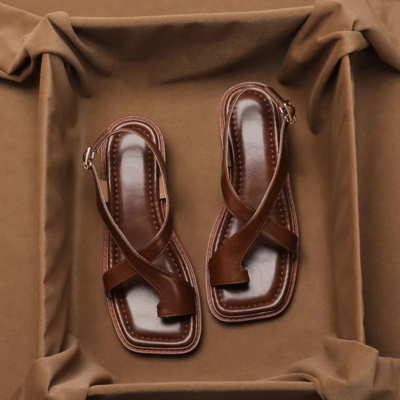 French retro brown toe ring sandals with square toe and ankle-strap buckle on a neutral background