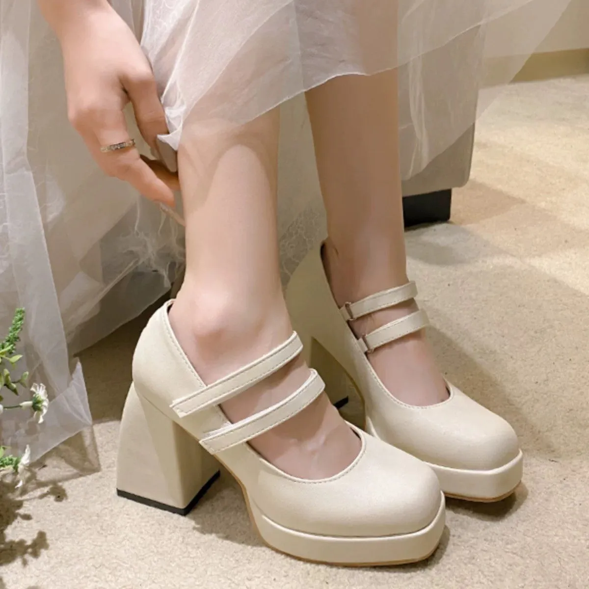 White Mary Jane chunky heel wedding shoes with square toe and buckle closure on a white background