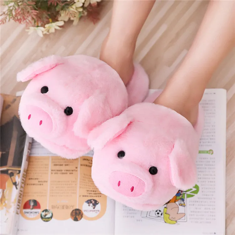 Pink pig-shaped plush indoor slippers with a cute animal face design, shown on a plain background.