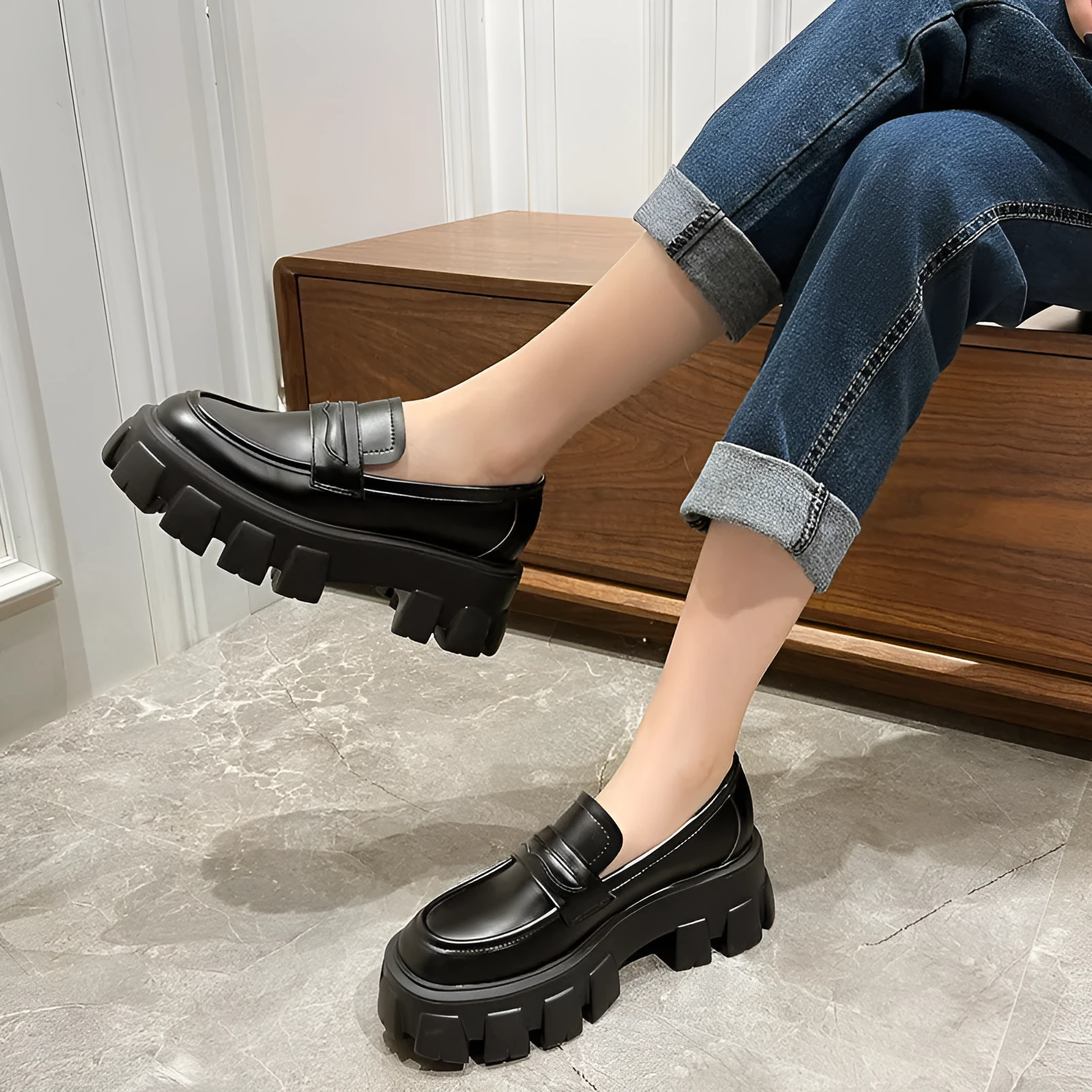 British style wide-fit patent leather loafers with a distinctive muffin heel on a rubber sole.