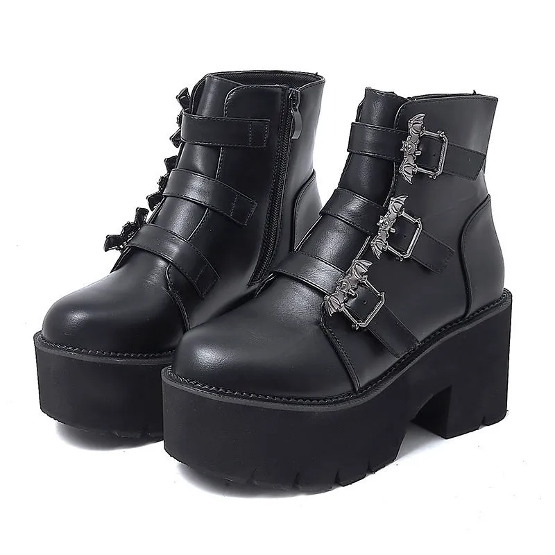 Black women's punk gothic Martin boots with bat buckle detail and side zipper.