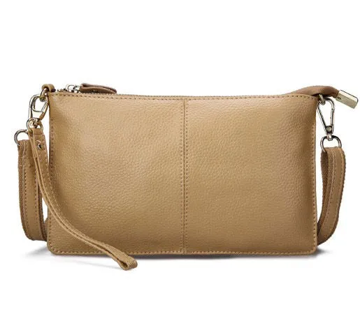 Lady's cowhide leather slant bag in apricot colour with hand strap and shoulder strap showing zipper compartments