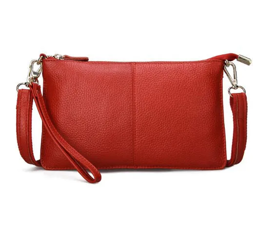 Lady's cowhide leather slant bag in apricot colour with hand strap and shoulder strap showing zipper compartments