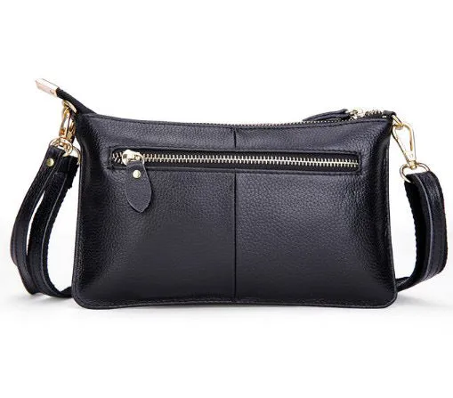 Lady's cowhide leather slant bag in apricot colour with hand strap and shoulder strap showing zipper compartments