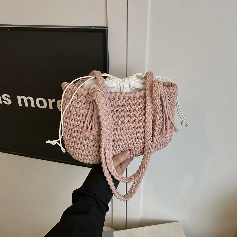Knitted bucket shoulder bag in beige with external sandwich pocket and sewing thread detail for women