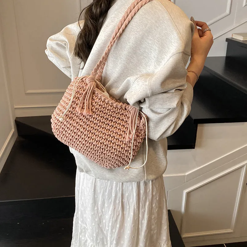 Knitted bucket shoulder bag in beige with external sandwich pocket and sewing thread detail for women