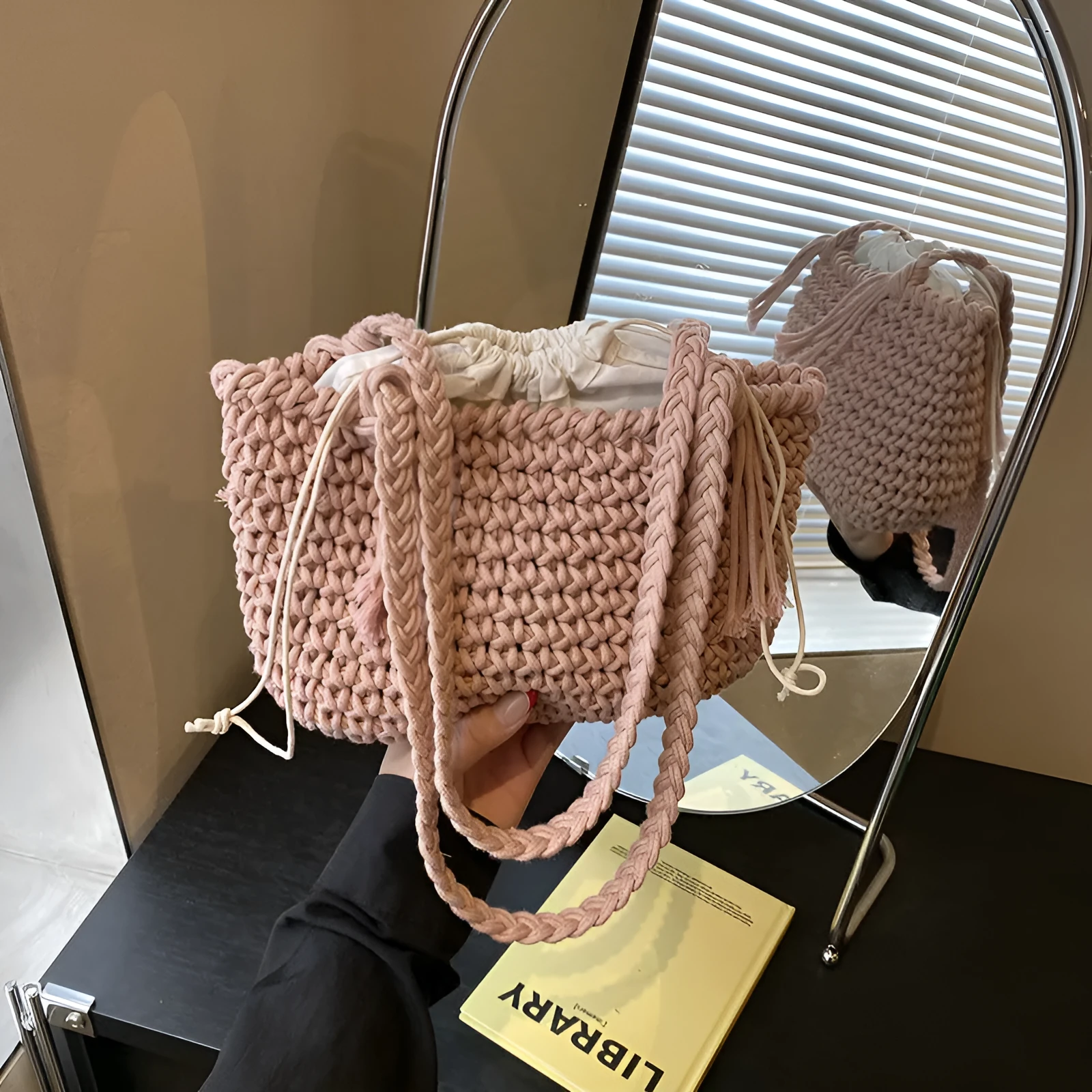 Knitted bucket shoulder bag in beige with external sandwich pocket and sewing thread detail for women