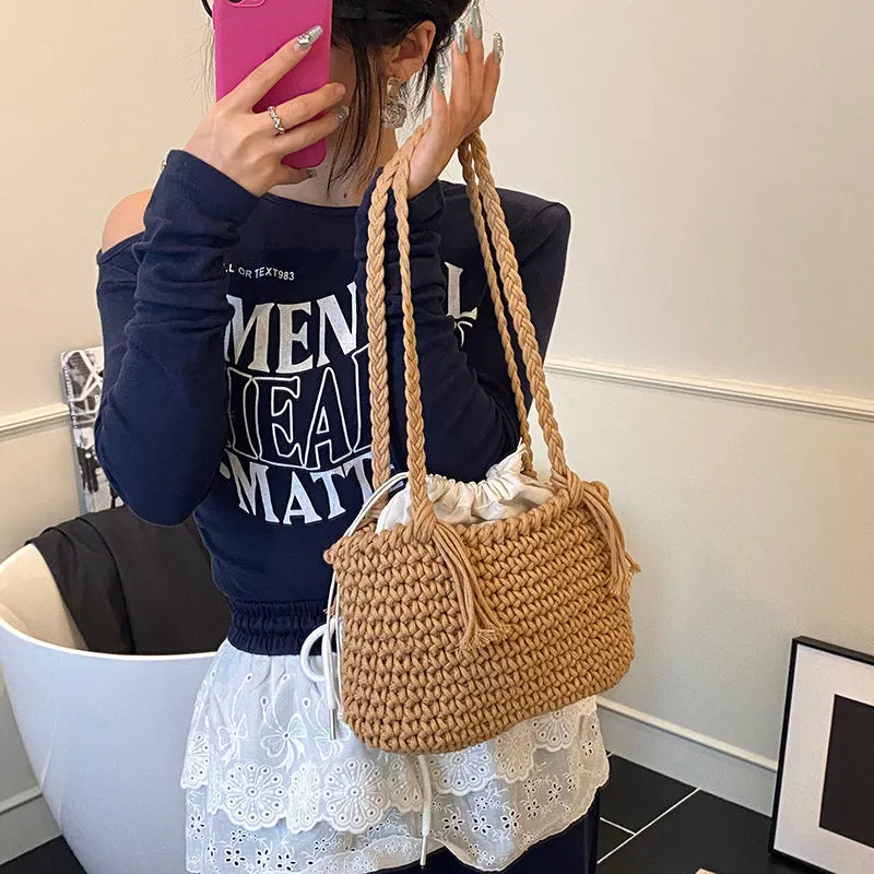 Knitted bucket shoulder bag in beige with external sandwich pocket and sewing thread detail for women