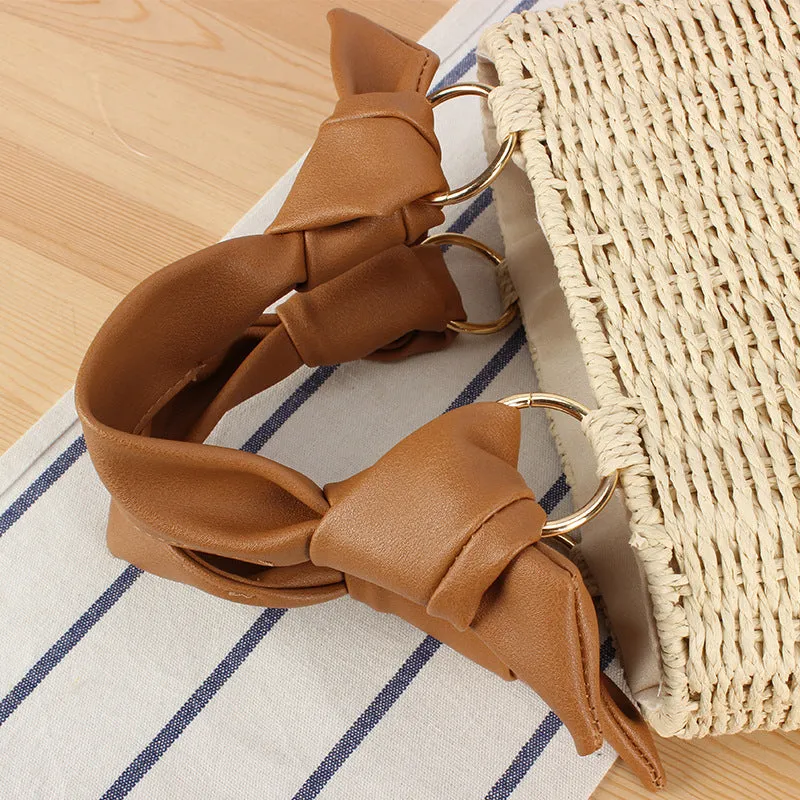 Portable woven straw bag in beige with hard trapezoid shape and double shoulder straps for seaside vacation daily use.