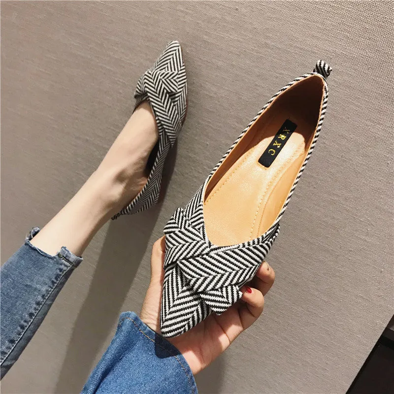 Women's black and red pointed toe shallow mouth casual shoes with a low flat heel.