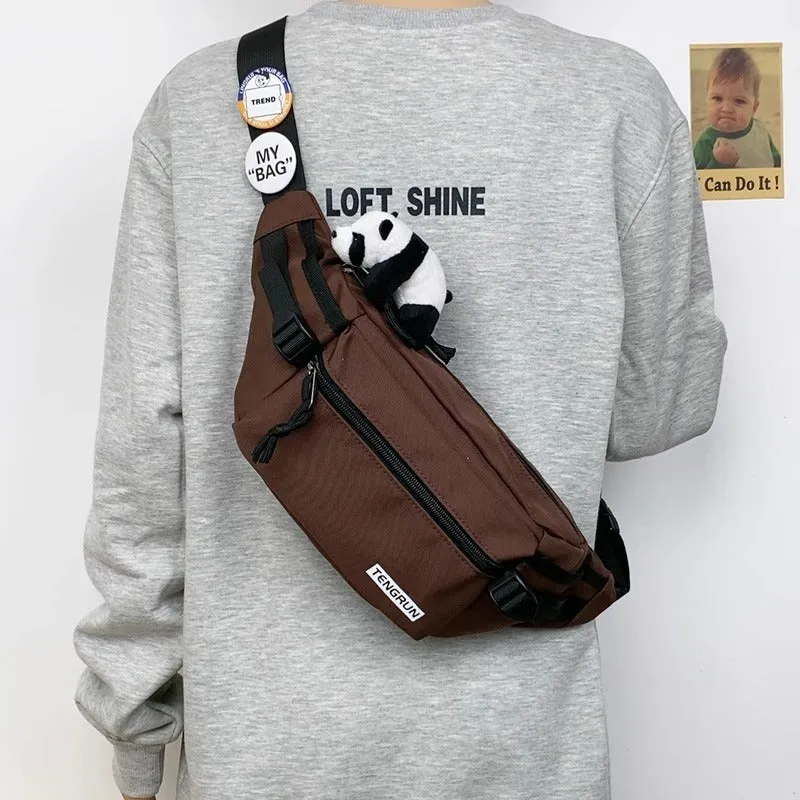Trendy chest bag for men in Oxford cloth with letter pattern, adjustable strap, and two random badges on a plain background
