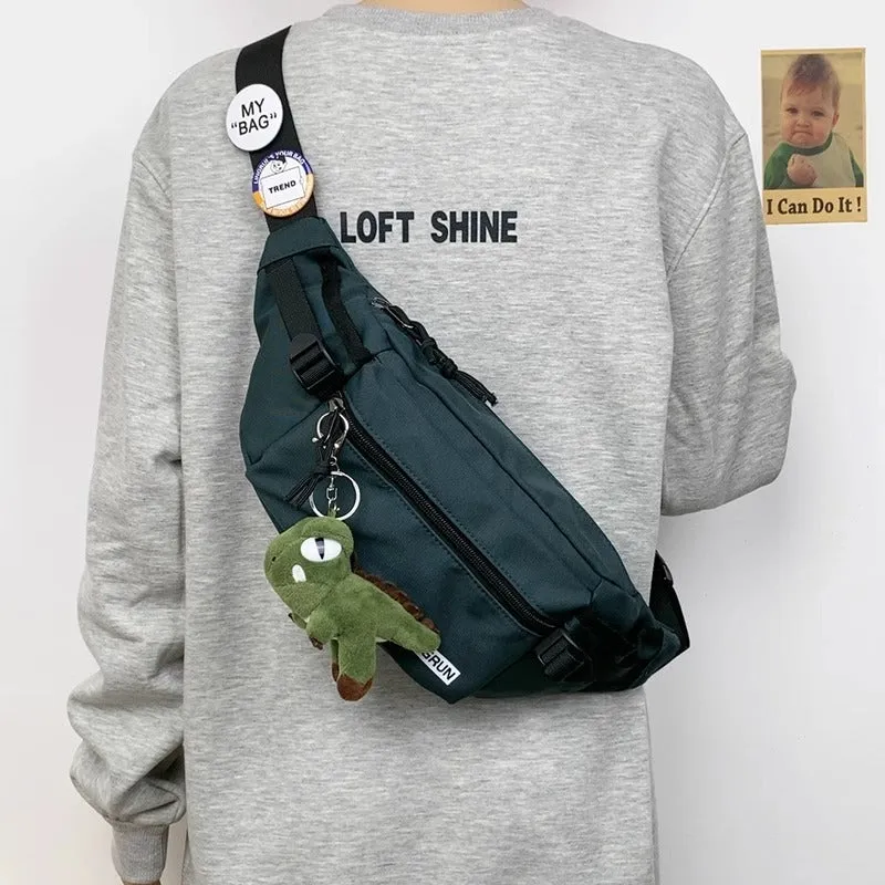 Trendy chest bag for men in Oxford cloth with letter pattern, adjustable strap, and two random badges on a plain background