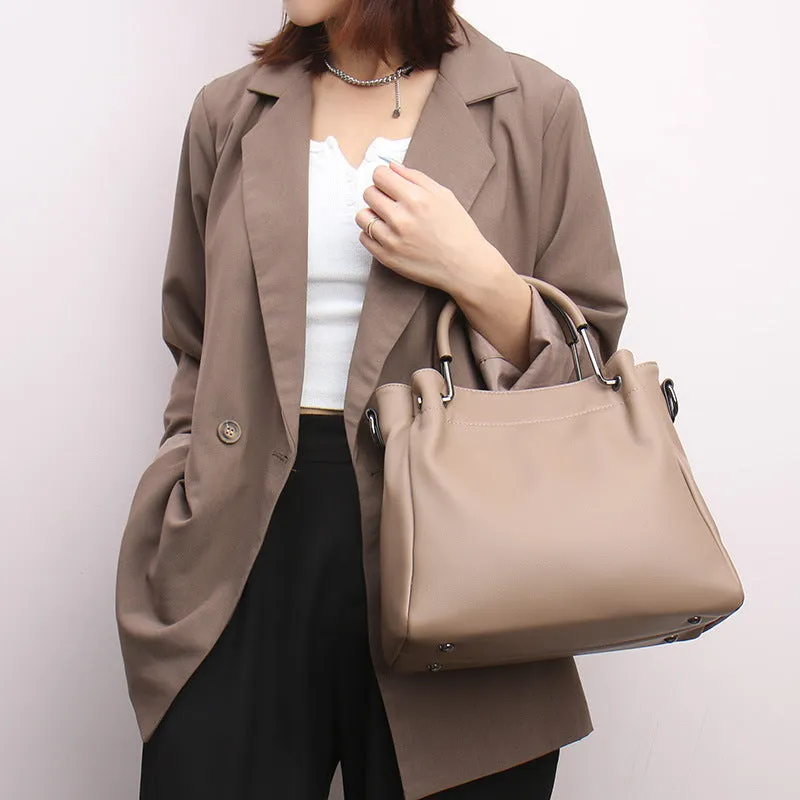Soft PU leather bucket bag in black with visible sewing thread and external slit pocket