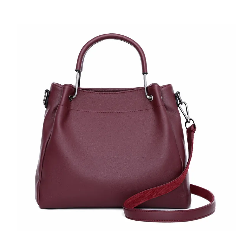 Soft PU leather bucket bag in black with visible sewing thread and external slit pocket