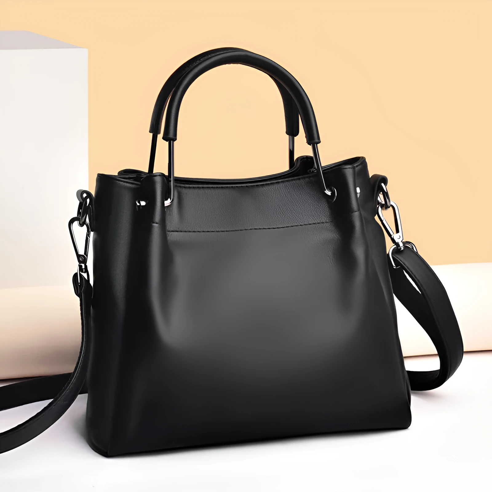 Soft PU leather bucket bag in black with visible sewing thread and external slit pocket