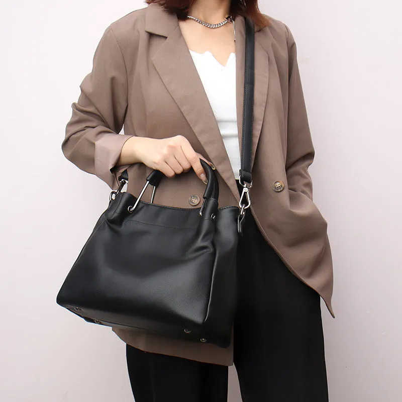 Soft PU leather bucket bag in black with visible sewing thread and external slit pocket