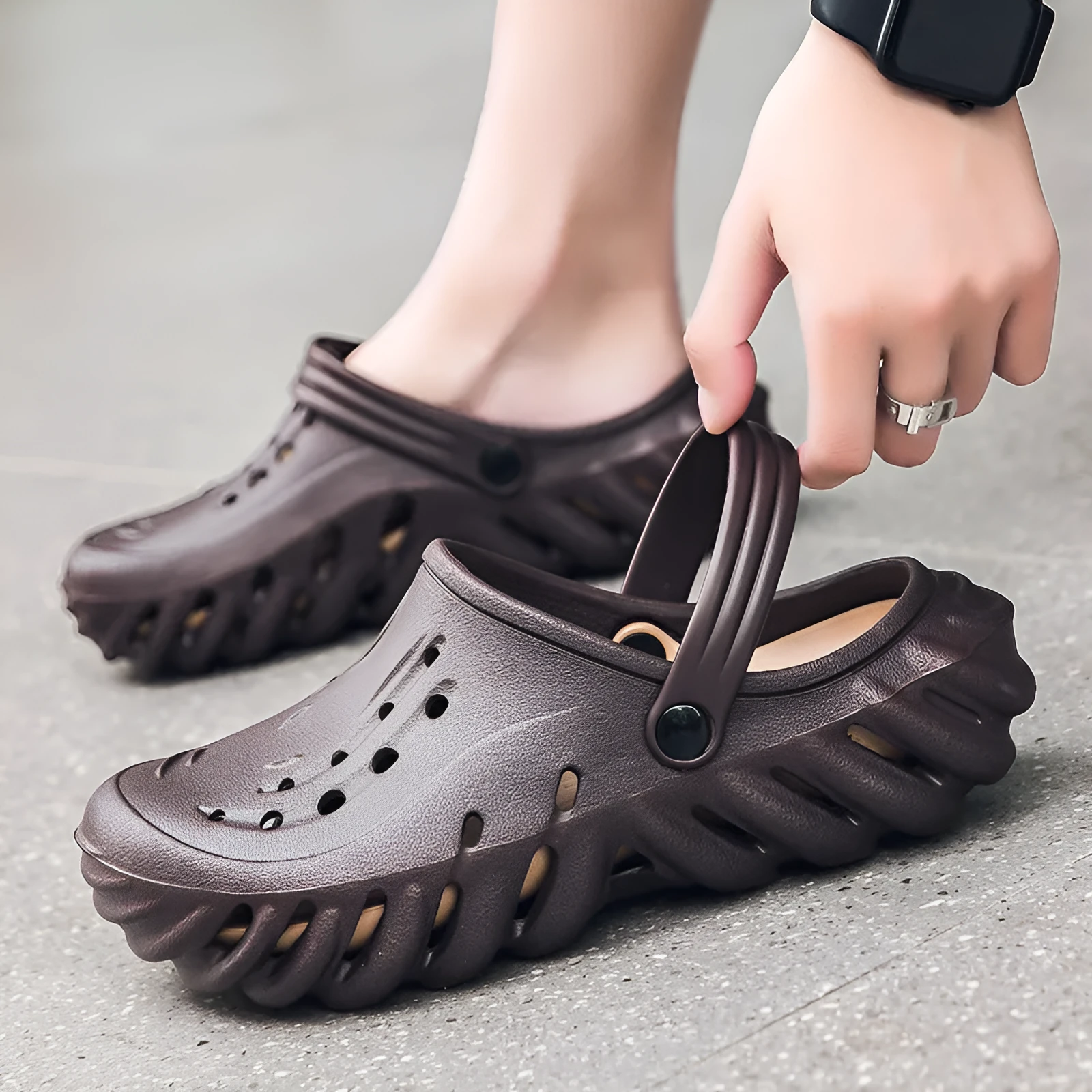 Men's beige EVA slipper sandals with hollow out design and round toe on a plain background.