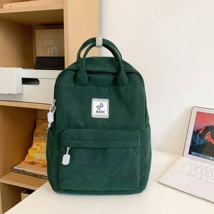 Retro hand-carrying backpack in light pink with breathable fabric, document pocket, and sewing line details for school use.