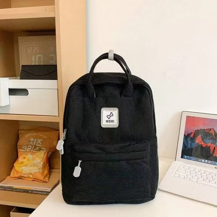 Retro hand-carrying backpack in light pink with breathable fabric, document pocket, and sewing line details for school use.