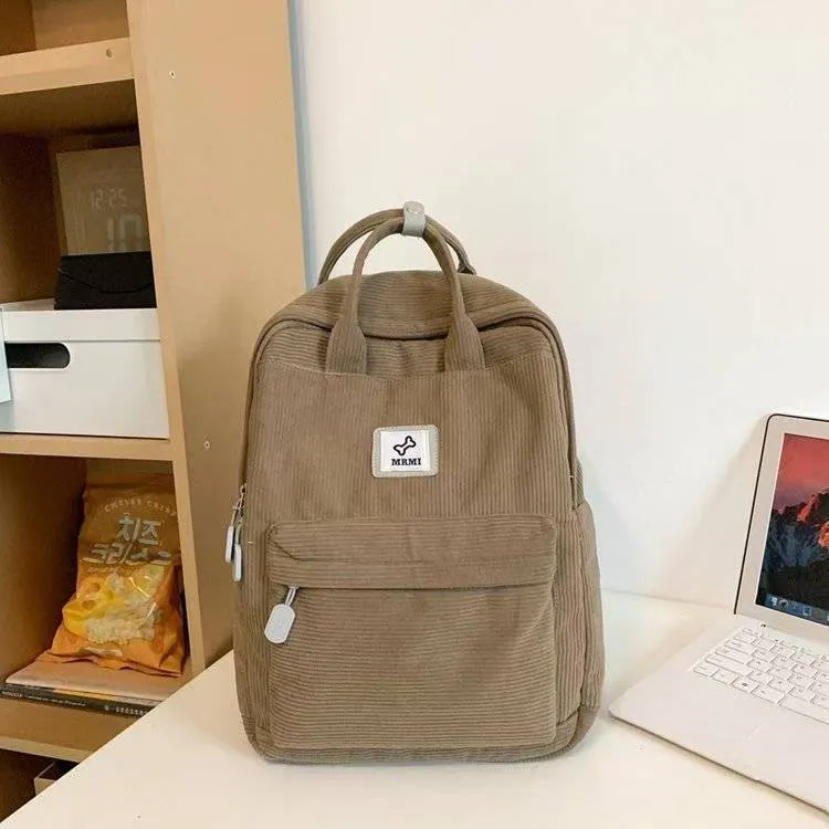 Retro hand-carrying backpack in light pink with breathable fabric, document pocket, and sewing line details for school use.