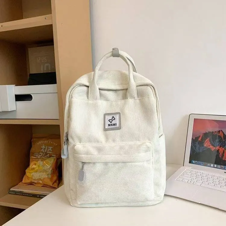 Retro hand-carrying backpack in light pink with breathable fabric, document pocket, and sewing line details for school use.
