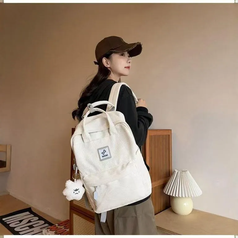 Retro hand-carrying backpack in light pink with breathable fabric, document pocket, and sewing line details for school use.