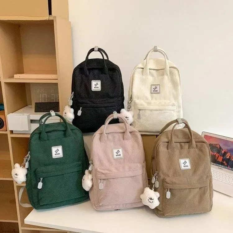 Retro hand-carrying backpack in light pink with breathable fabric, document pocket, and sewing line details for school use.