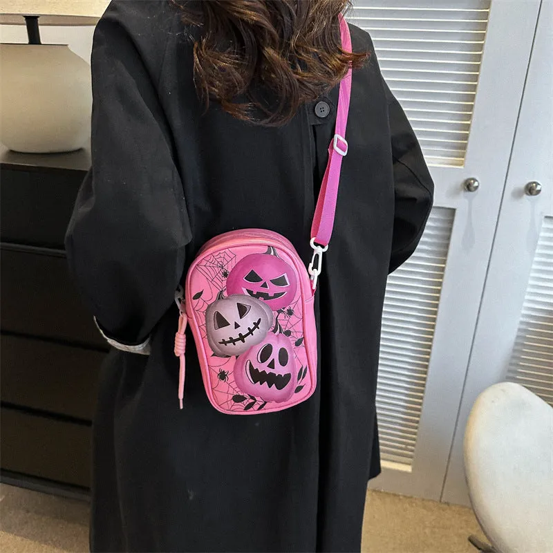 Black Halloween crossbody bag with orange pumpkin, white ghost, and bat graffiti print, shown on a model.