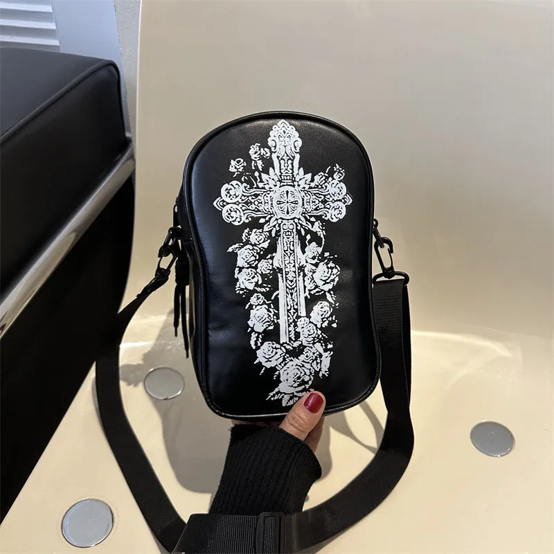 Black Halloween crossbody bag with orange pumpkin, white ghost, and bat graffiti print, shown on a model.