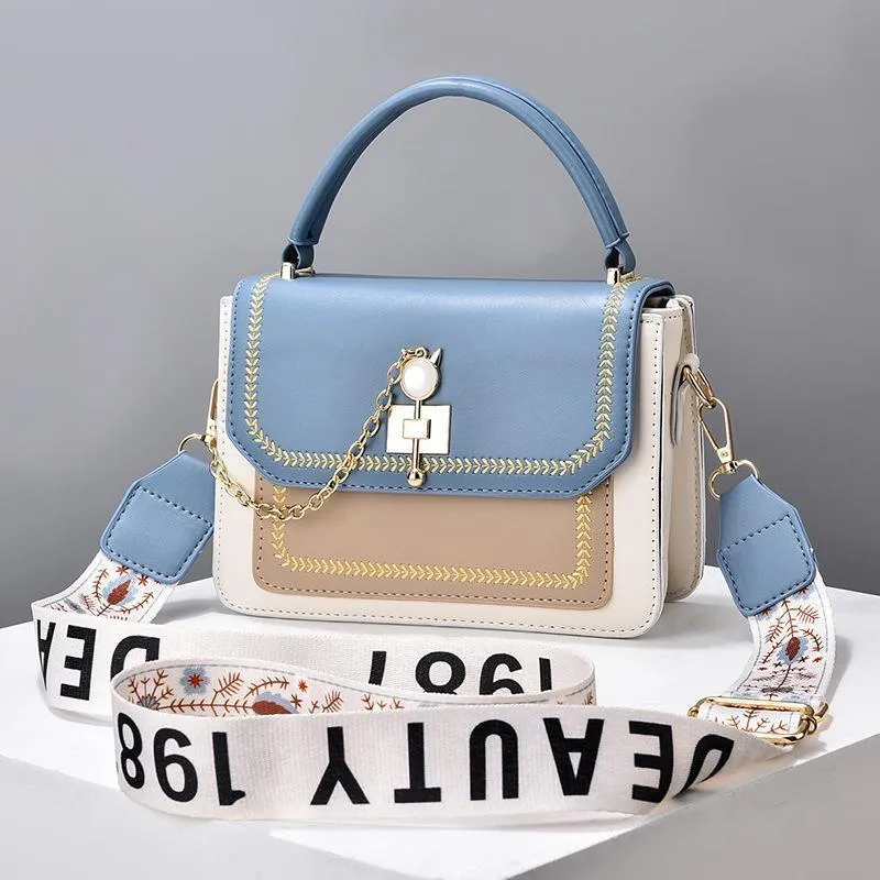 Large capacity PU shoulder bag with wide strap, embroidery detail, and contrast colour in black