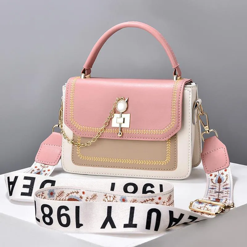 Large capacity PU shoulder bag with wide strap, embroidery detail, and contrast colour in black