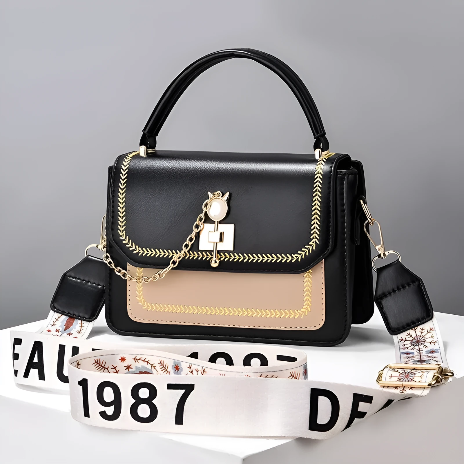 Large capacity PU shoulder bag with wide strap, embroidery detail, and contrast colour in black