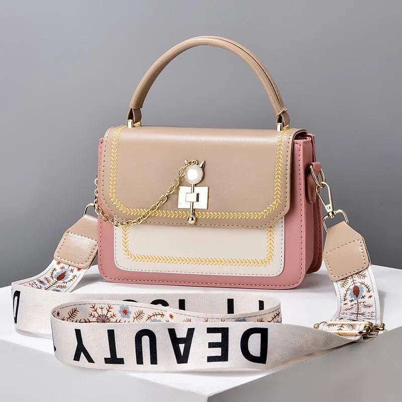 Large capacity PU shoulder bag with wide strap, embroidery detail, and contrast colour in black