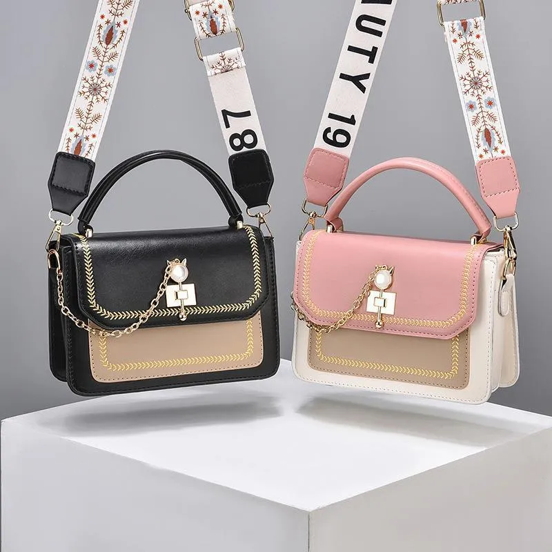 Large capacity PU shoulder bag with wide strap, embroidery detail, and contrast colour in black