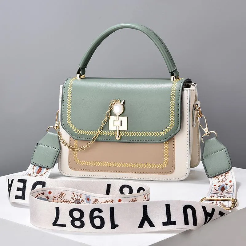 Large capacity PU shoulder bag with wide strap, embroidery detail, and contrast colour in black