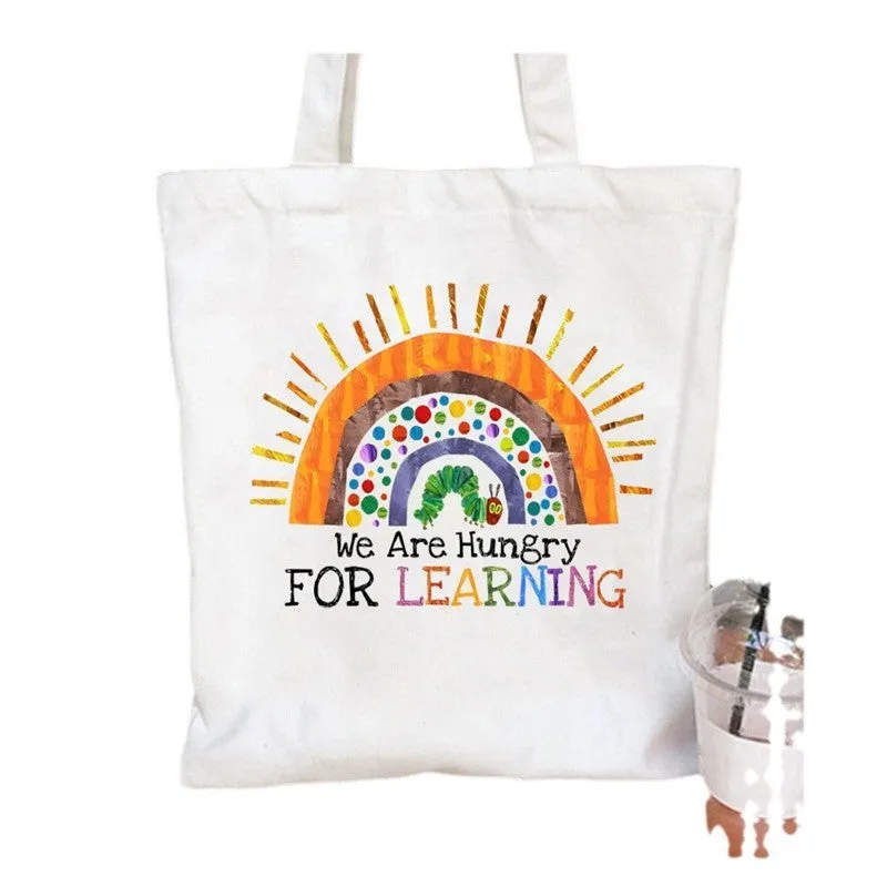 Women's canvas tote bag with printed letter pattern and chain detail in urban simplicity style