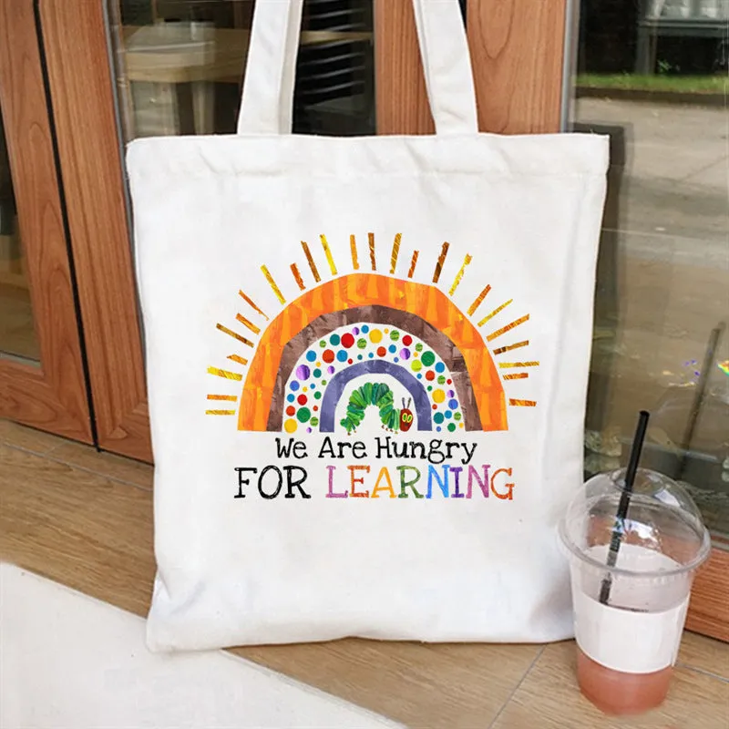 Women's canvas tote bag with printed letter pattern and chain detail in urban simplicity style