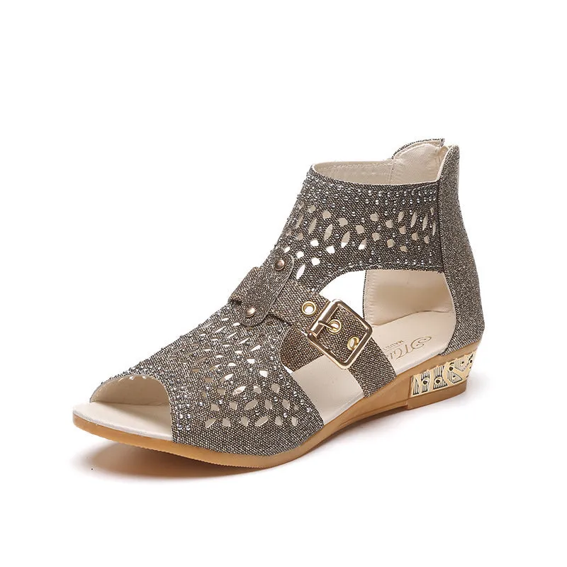Women's beige flat sandals with back zipper and low wedge heel on a white background.