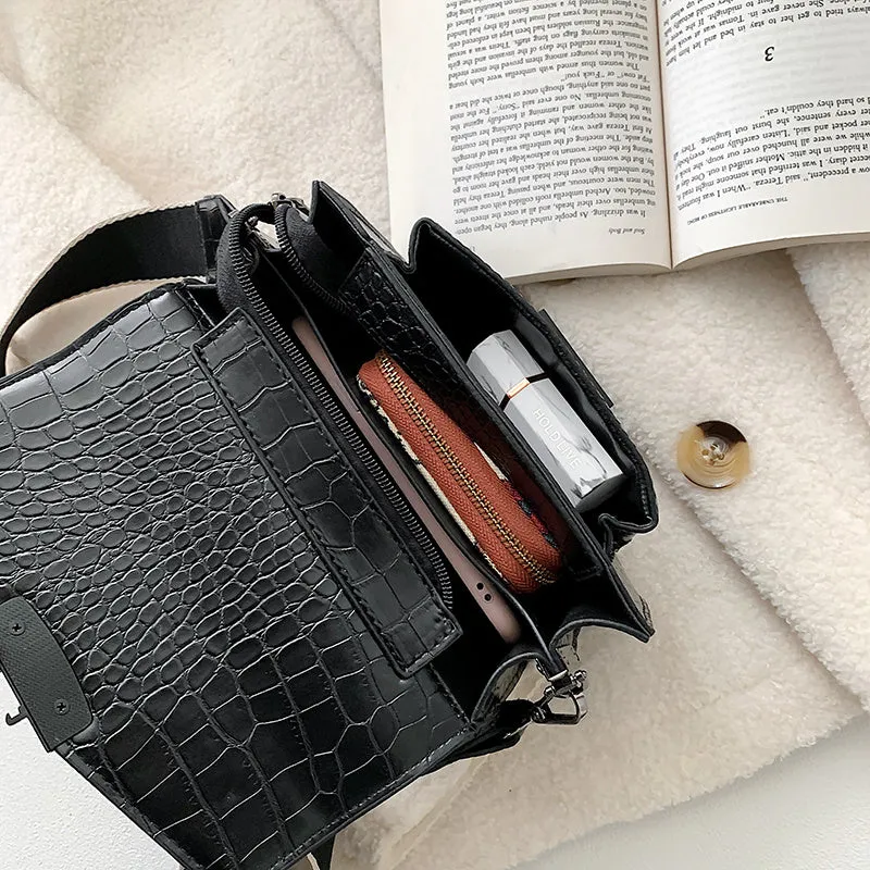 Vintage-style black PU crossbody bag with adjustable strap showing interior