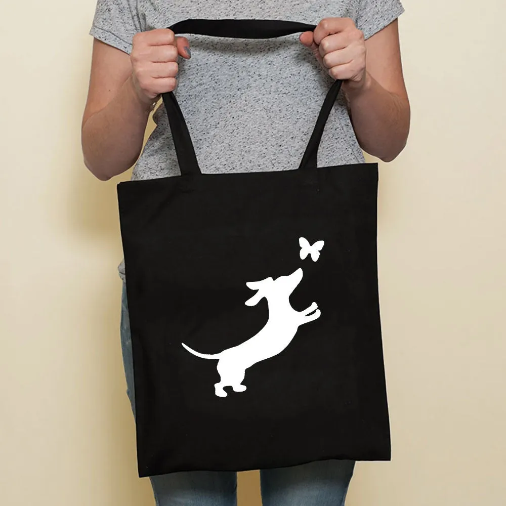 Sausage dog printed canvas bag in black with white dog design on front, sturdy tote for everyday use