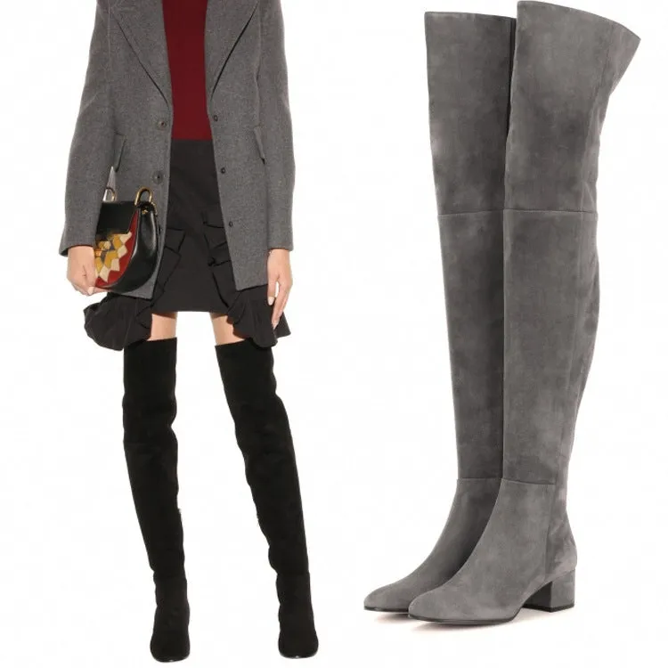Grey suede women's over the knee flat boots with a pointed toe and thick low heel on a neutral background.