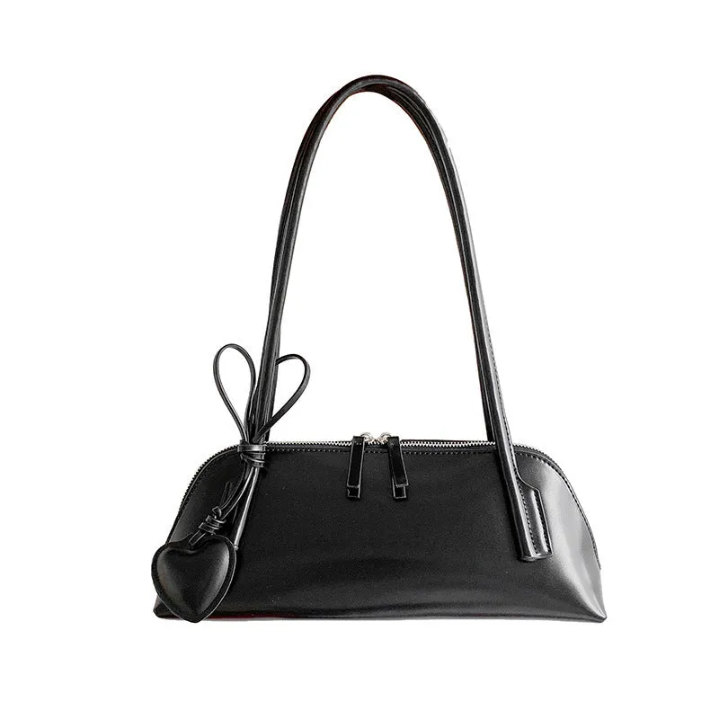 Crossbody shoulder bag in black PU with double straps, horizontal square shape, and visible sewing thread detail on front