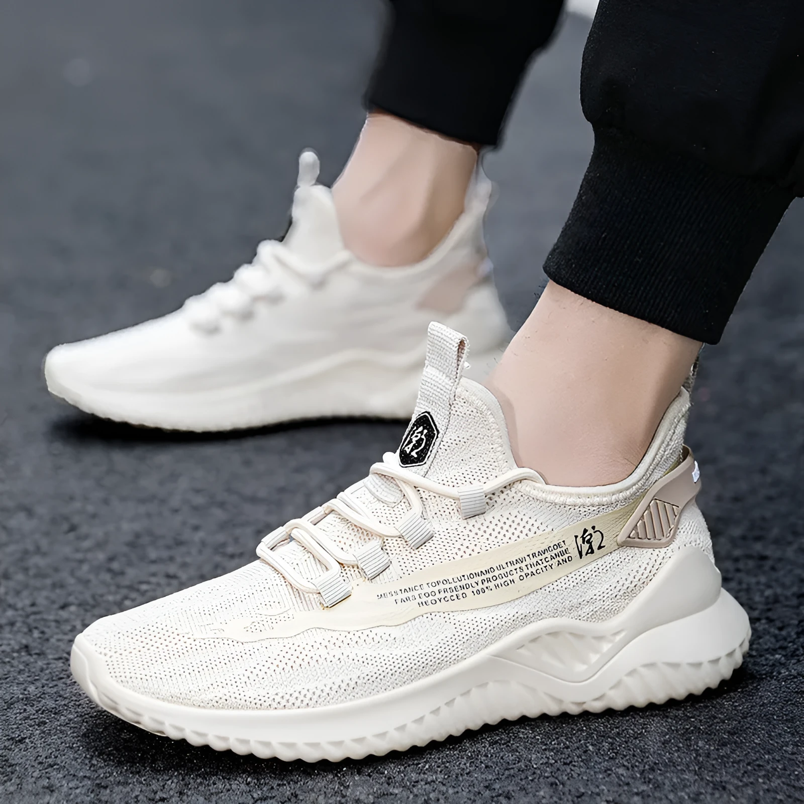 Men's white low-top lace-up trainers with mesh upper and rubber sole on a plain background.